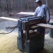 Paul plaining wood at the shop.